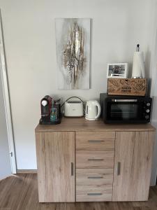 a microwave on top of a wooden cabinet in a room at Appartement Petra in Bruck an der Großglocknerstraße