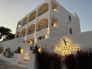 a white building with a sign in front of it at Alexander Suites in Drios