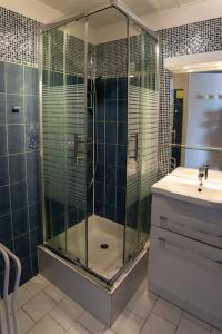 a bathroom with a glass shower and a sink at Studio 4 People - Christmas Market - Port - Beach in Le Barcarès