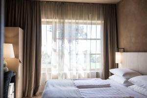 Кровать или кровати в номере ADLER Spa Resort SICILIA