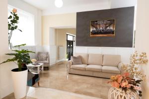 a living room with a couch and a wall with a picture at Hotel DSZSU in Trenčianske Teplice