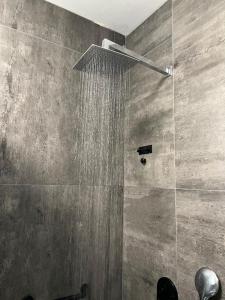 a bathroom with a shower with a shower head at stylish apartment by the SEA in Ashdod