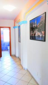 a hallway with a wall with a painting on it at Orosei RE - Villa Osala - 800 m dal mare in Orosei