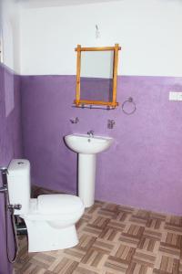 a bathroom with a white toilet and a sink at Seasons Four Jungle Cabana - Breakfast - Beach 10Mtr- Wildlife in Matara