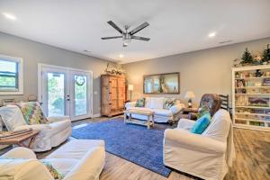 a living room with white furniture and a ceiling fan at Spring City Home Lakefront Boating Getaway! in Spring City