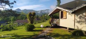 a small house with a view of a mountain at Village de Vacances Les 4 Chemins in Soueix