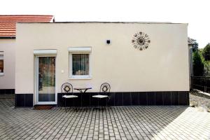 eine Terrasse mit 2 Stühlen und einem Tisch auf einem Gebäude in der Unterkunft Alpok-Spirit Apartment – Velem in Velem