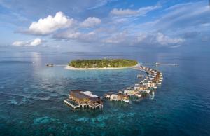 an island with a dock in the water at Park Hyatt Maldives Hadahaa in Gaafu Alifu Atoll