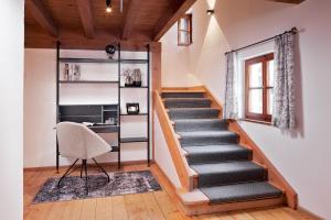 a staircase in a room with a chair and a desk at Chalet Gletscherblick in Sankt Anton am Arlberg