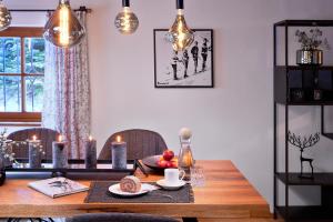 a dining room table with candles and food on it at Chalet Gletscherblick in Sankt Anton am Arlberg