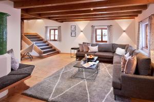 a living room with a couch and a table at Chalet Gletscherblick in Sankt Anton am Arlberg