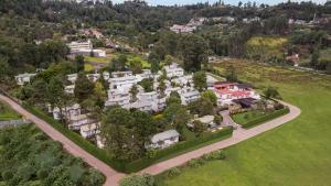 an aerial view of a large house with trees at Sterling Kodai Lake in Kodaikānāl