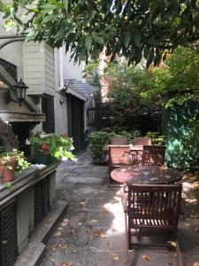 a patio with a table and chairs in a yard at Posada Don Jaime in San Lorenzo de El Escorial