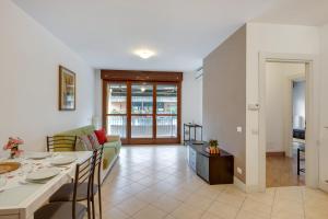 a living room with a couch and a dining room at Il Broletto Apartment - Affitti Brevi Italia in Lecco