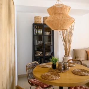 a dining room with a table and a black cabinet at Modern apartment directly on the beach with WiFi and air conditioning in El Campello