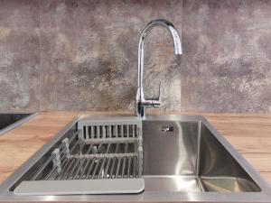 a stainless steel kitchen sink with a faucet at НОВОБУДОВА ЧЕРВОНОЇ КАЛИНИ 56А Сихів, АВАЛОН,ВИСОТКА in Lviv