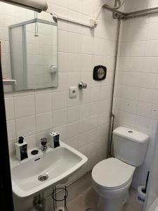 a bathroom with a toilet and a sink at Espaço_Zero[Downtown] 01 in Porto +2 photos