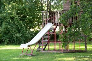 a slide on a playground in a park at Maison de 6 chambres avec jardin amenage et wifi a Lametz in Lametz