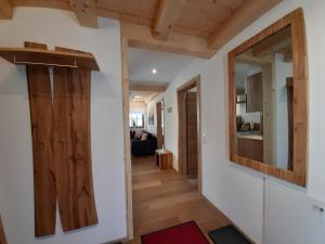 a hallway leading to a living room with a mirror at Hochalmbahnen Chalets Rauris 1-08WE1, Maislaufeldweg 1e EG in Rauris
