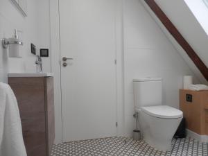 uma casa de banho branca com um WC e um lavatório em Lar Azul em Redondela