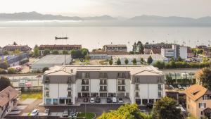 an aerial view of a city with a large building at Lodges Hotel Morges in Morges