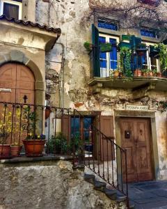 an old building with potted plants and a door at Ottanio Lake Apartment in Pisogne