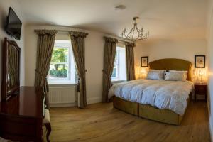 a bedroom with a bed and a chandelier at Boyne View House in Trim