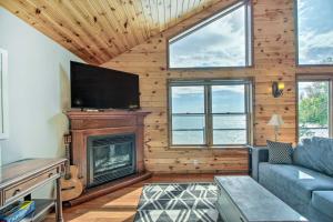 a living room with a fireplace and a tv at Delightful Isle Retreat with Boat Dock and Slip! in Isle
