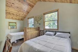a bedroom with two beds and two windows at Delightful Isle Retreat with Boat Dock and Slip! in Isle