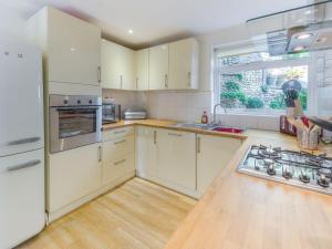 a kitchen with white cabinets and a white refrigerator at Bridles 20 Park Place in Arundel