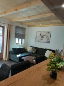 a living room with a couch and a table at Hochalmbahnen Chalets Rauris 1-15 WE1, Maislaufeldweg 1o EG in Rauris