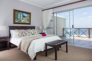 a bedroom with a bed with a view of the ocean at Brenton On The Rocks in Knysna +58 photos