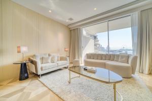 a living room with a couch and a table at FIVE Palm Jumeirah Residences - Mint Stay in Dubai