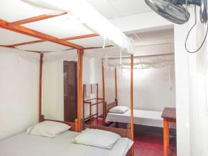 a room with two beds and a desk in it at Sheen Holiday Resort in Tangalle