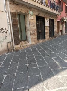 an empty street in front of a building with graffiti at Dimora Italia in Campobasso