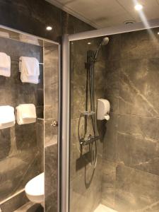 a bathroom with a shower with a glass door at Maison Richet in Les Sables-d'Olonne