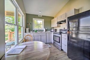 une cuisine avec une table en bois et un réfrigérateur dans l'établissement Bean Station Cottage Unobstructed Lake Views, à Bean Station