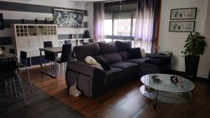 a living room with a couch and a table at Chalet Adosado in Moaña