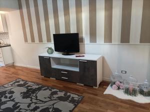 Dimora Italia في كامبوباسو: غرفة معيشة مع تلفزيون بشاشة مسطحة على خزانة