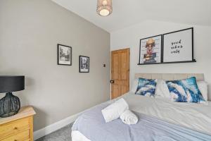 a bedroom with a bed and a night stand with a lamp at Central House with Parking, Pool Table, Super-Fast Wifi and Smart TV with Virgin TV and Netflix by Yoko Property in Northampton