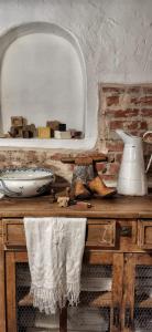 a table with a mirror and a vase on it at B&B CUCUTÍ in Ziano Piacentino