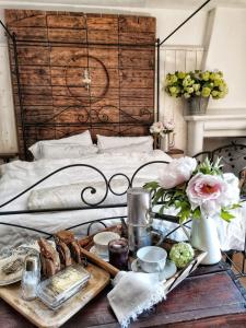 a tray of food on a table next to a bed at B&B CUCUTÍ in Ziano Piacentino
