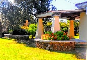 a gazebo with flowers in a yard at Orosei RE - Villa Osala - 800 m dal mare in Orosei +19 photos