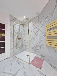 bagno con doccia e pareti in marmo di Maison Chic avec jacuzzi. UrbanSpa60 a Nogent-sur-Oise