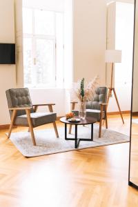 a living room with two chairs and a coffee table at Dvorac Janković in Suhopolje