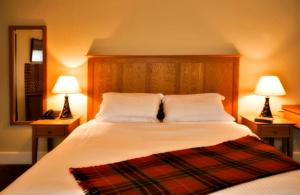 a bedroom with a large bed with two lamps at Westgate House B&B Strokestown in Strokestown