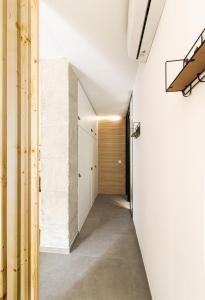 a hallway with white walls and concrete floors at La Habitación del Arquitecto in Granada