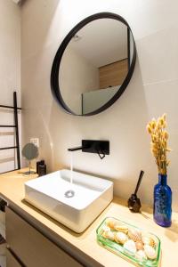 a bathroom with a white sink and a mirror at La Habitación del Arquitecto in Granada