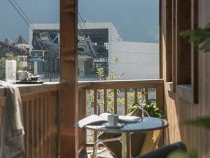 a balcony with a table and a cup of coffee at Apart Central – Premium Mountain&Garden in Mayrhofen