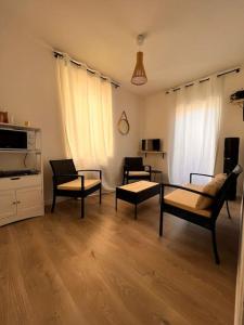 sala de estar con sillas, mesa y sofá en Homelove Spa en Neuilly-en-Thelle